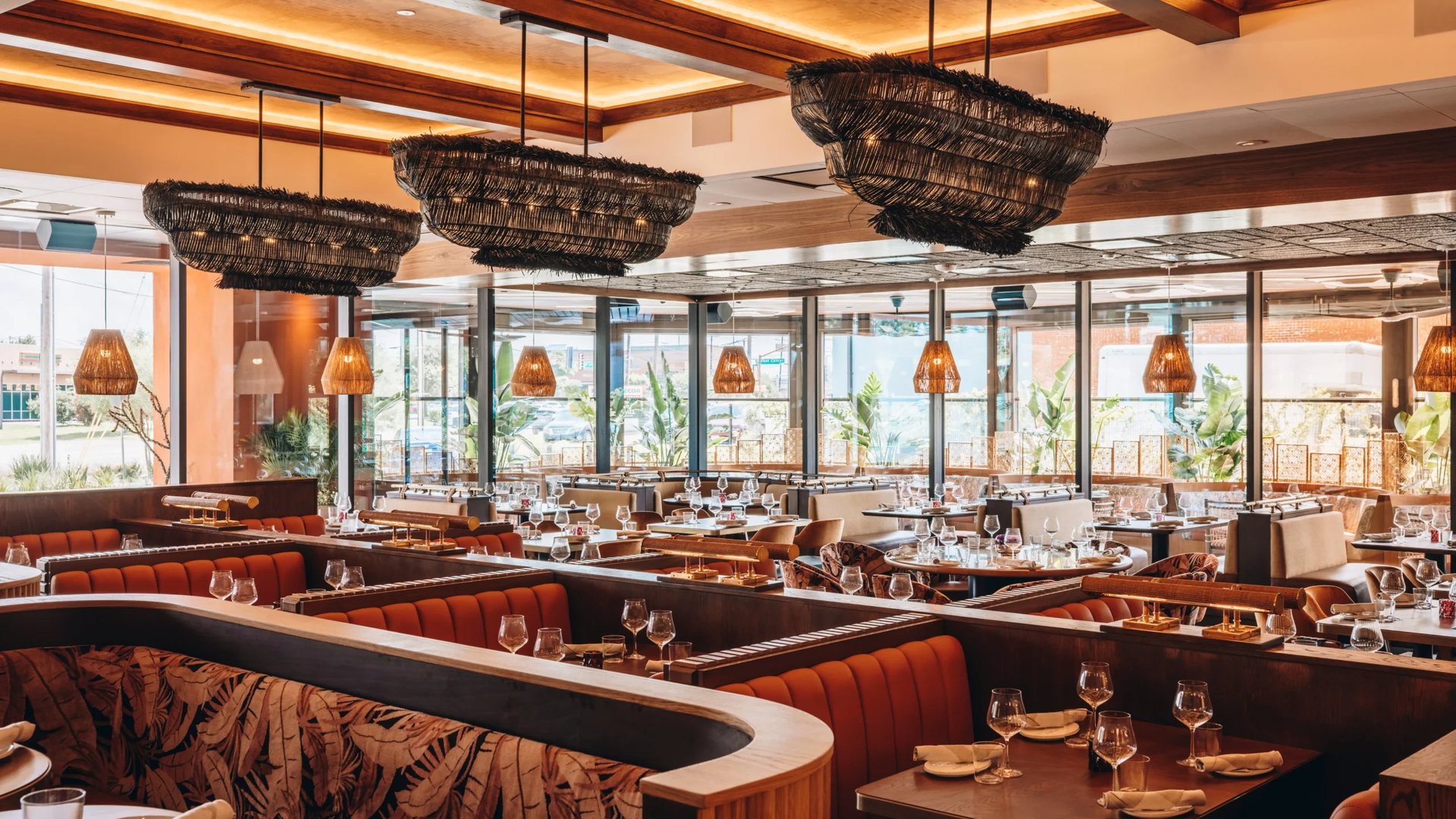 Maroma's dining room with booths beside tall windows
