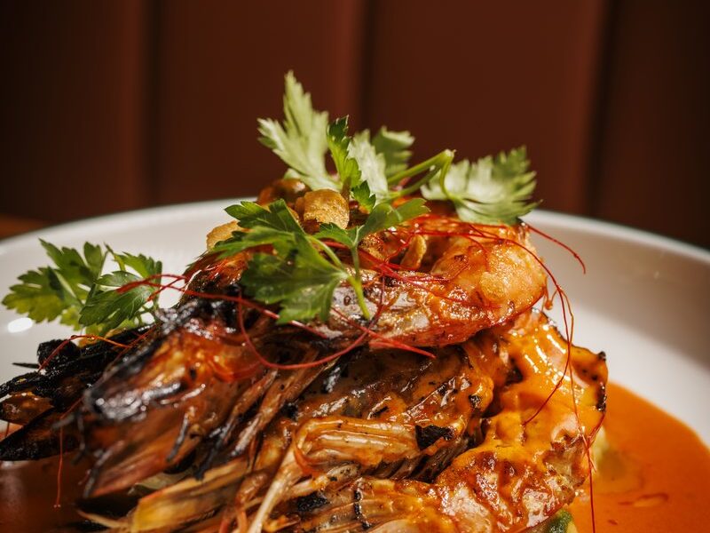 Mesquite-grilled jumbo prawns in chile butter sauce with herbs