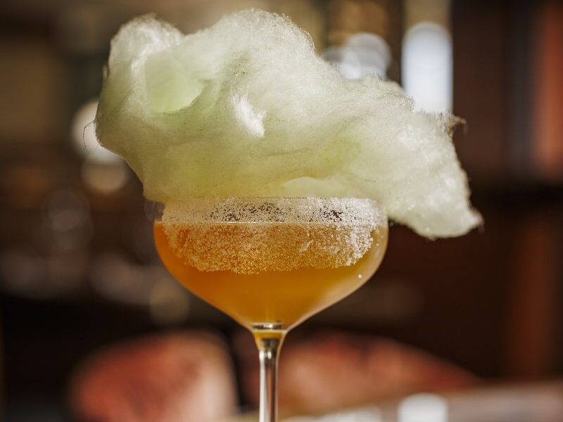 The Corona y Caña cocktail topped with piña colada candy floss
